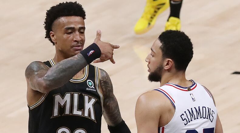 Hawks forward John Collins reacts to hitting a three pointer against Philadelphia 76ers guard Ben Simmons during the fourth quarter of a 103-100 victory over the 76ers in Game 4 of the Eastern Conference semifinals Monday, June 14, 2021, in Atlanta. (Curtis Compton / Curtis.Compton@ajc.com)