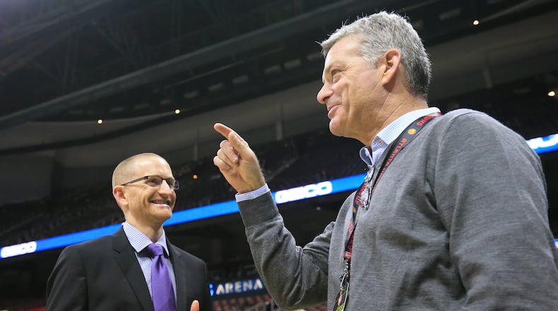 Hawks owner Tony Ressler (right) and general manager Wes Wilcox (left) confer before a game in 2015. Curtis Compton / ccompton@ajc.com