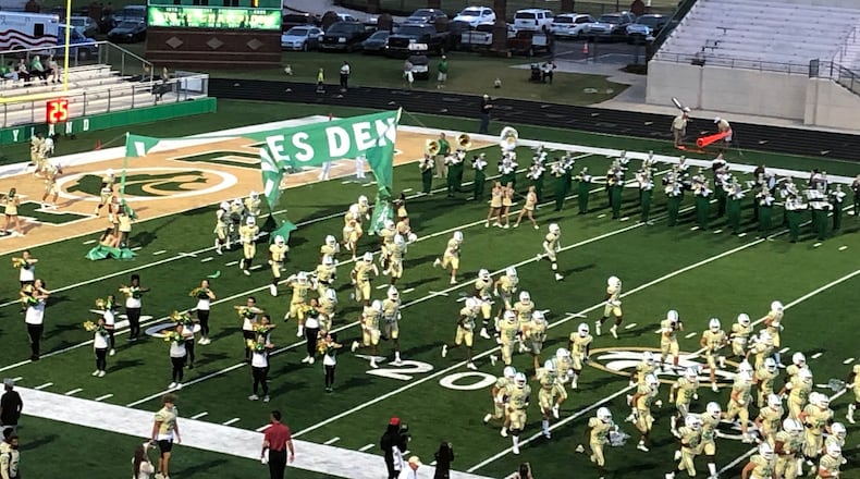 The Buford High School football team breaks through the banner to start its game with Chaminade, Fla. Buford lost 7-0 on Sept. 17, 2021.
