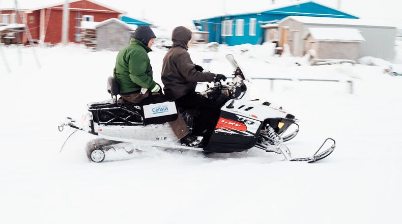 Two census workers, Tim Metzger, left, and Dennis Kashatok, travel in  Alaska, by snowmobile.  (Joshua Corbett/The New York Times)