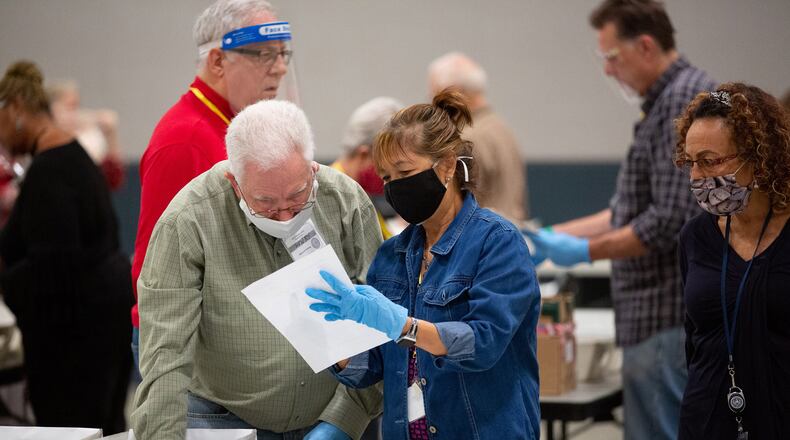 Cobb County election staff check ballots during the recount of the presidential ballots on Nov. 13. Georgia began its third tally in the presidential race Tuesday. (Steve Schaefer/Atlanta Journal-Constitution/TNS)