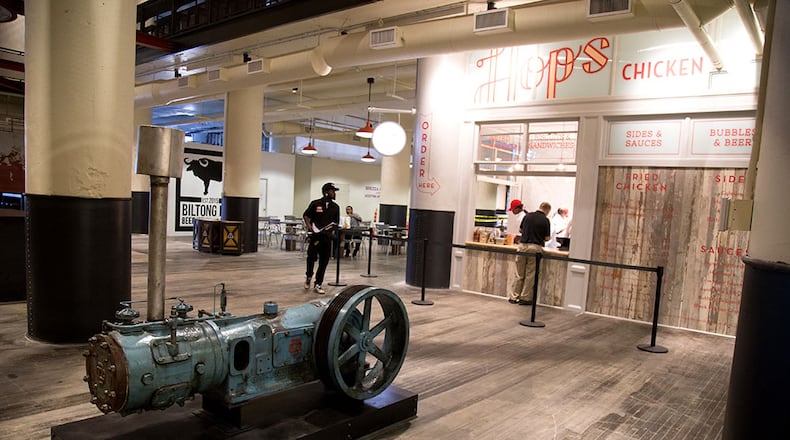 An original air and gas compressor sits in the lobby of Ponce City Market. STEVE SCHAEFER / SPECIAL TO THE AJC