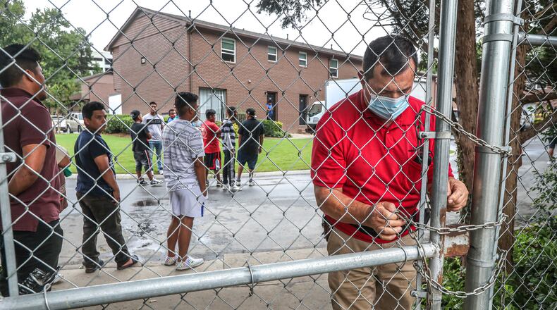 Apartment management locked a gate residents use to travel to nearby stores at the scene where a knife attack led to a police shooting at the Chamblee complex on Wednesday, Sept. 22, 2021. Officers responded to a domestic violence call in the 3200 block of Chamblee Dunwoody Road just after 6:30 a.m. That call escalated into an officer-involved shooting.