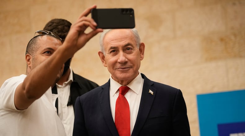 A man takes a selfie with Israeli Prime Minister Benjamin Netanyahu during the Likud party primary elections ahead of Israel's general election in October, in Jerusalem, Monday, Aug. 17, 2026. (AP Photo/Ohad Zwigenberg, Pool)