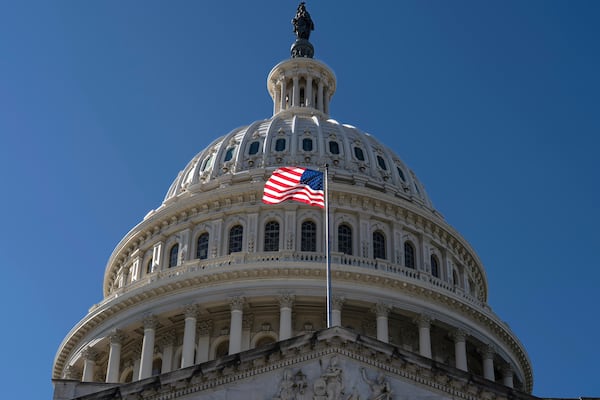 The American flag flies over the Capitol in Washington. (J. Scott Applewhite/AP)