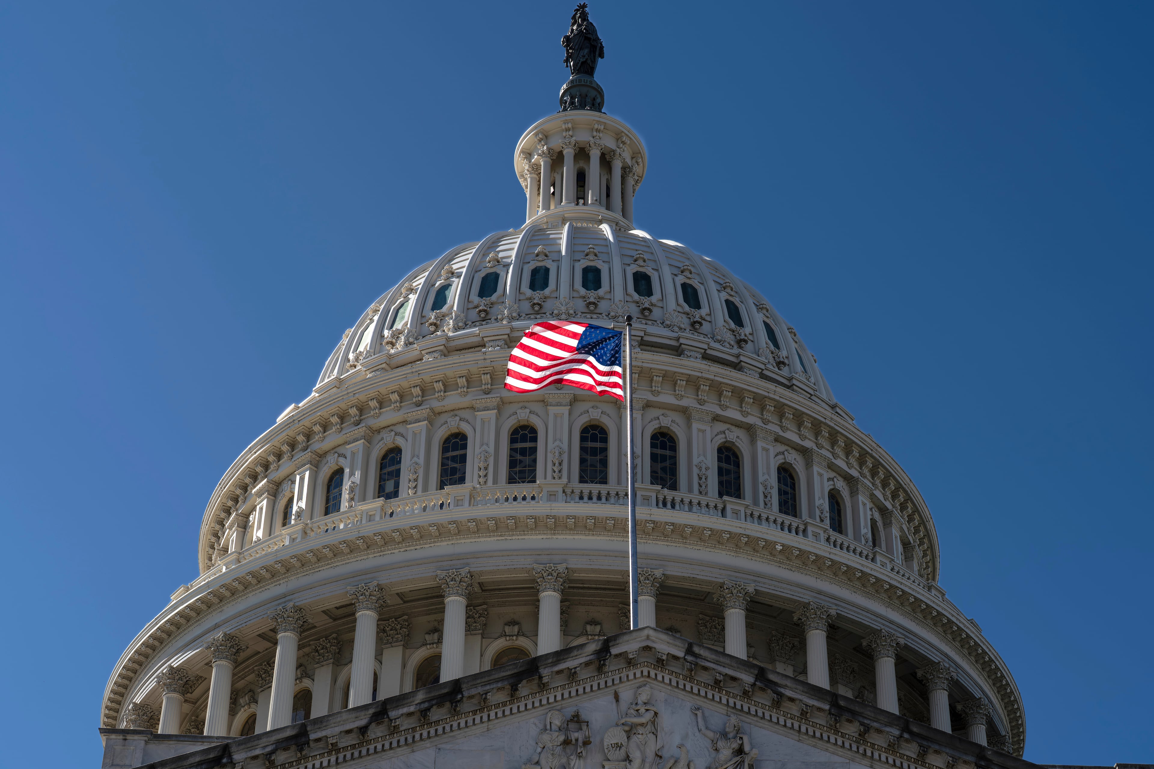 The American flag flies over the Capitol in Washington. (J. Scott Applewhite/AP)
