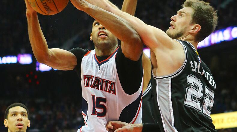 Center-power forward Tiago Splitter, shown here with San Antonio defending Hawks center Al Horford this past season, is now a Hawk after Wednesday's trade. (Curtis Compton/ccompton@ajc.com)