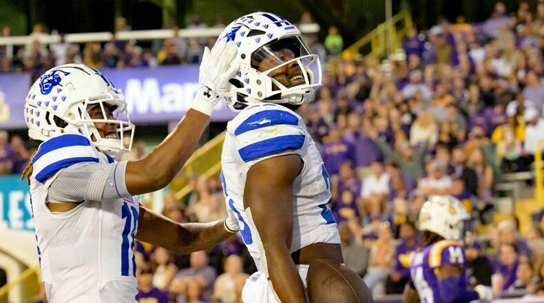Georgia State running back Marcus Carroll, right, celebrates after his touchdown with wide receiver Tailique Williams, left, during the first half of an NCAA college football game against LSU in Baton Rouge, La., Saturday, Nov. 18, 2023. (AP Photo/Matthew Hinton)