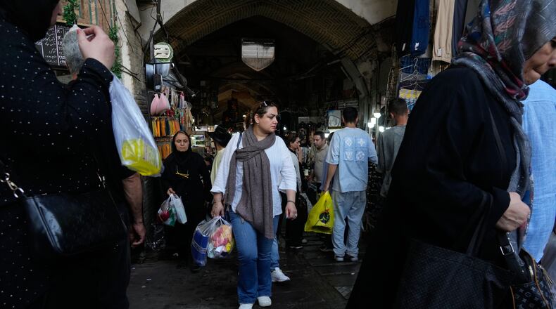 People walk at Tehran's traditional main bazaar, Iran, Saturday, Aug. 8, 2026. (AP Photo/Vahid Salemi)