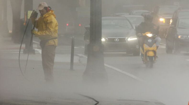 Thick fog envelopes workers and commuters in downtown Atlanta Monday morning.