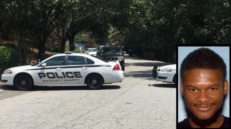 Police cars block off a cul-de-sac where a man and teenage boy were shot in Snellville on Thursday. Police have issued arrest warrants for Trevaughn McBriar, 18, in connection with the shooting.
