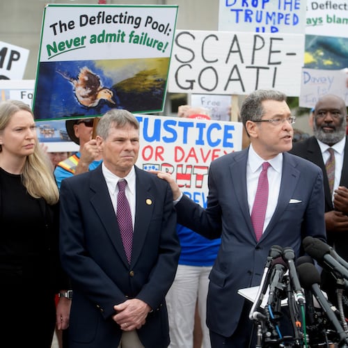 Former Olympic canoeist David Hearn, second from left, listens as his attorney Norman Eisen, right, speaks after he pleaded not guilty to allegedly damaging the Lincoln Memorial Reflecting Pool, Thursday, July 9, 2026, in Washington. (AP Photo/Rod Lamkey, Jr.)