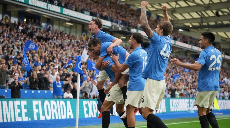 Brighton players celebrate after third goal during the English Premier League soccer match between Brighton & Hove Albion and Arsenal in Brighton, England, Saturday, Sept. 19, 2026. (AP Photo/Kin Cheung)