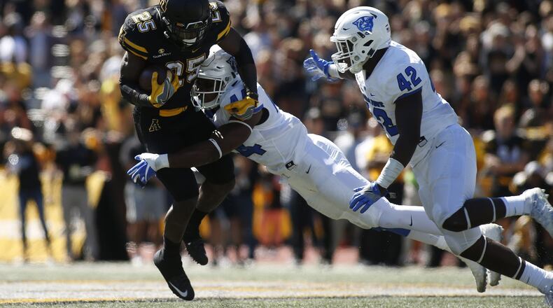 Running back Jalin Moore of Appalachian State is stopped on a carry by GSU linebacker Michael Shaw (44) and linebacker Trey Payne during the second quarter on Oct. 1, 2016 at Kidd Brewer Stadium in Boone, N.C. (Photo by Brian Blanco/Getty Images)