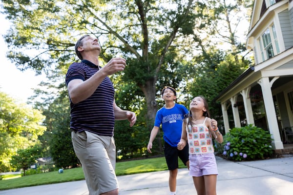 Dr. James Rilling plays outside with his two children. (Courtesy of Kay Hinton, Emory University) 