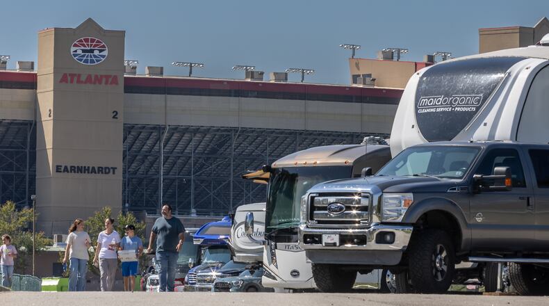 Many evacuees fleeing Hurricane Milton parked their RVs at Atlanta Motor Speedway this week. The Gagne family, who evacuated from Naples, walks back to their RV after being treated to free pizza Wednesday.