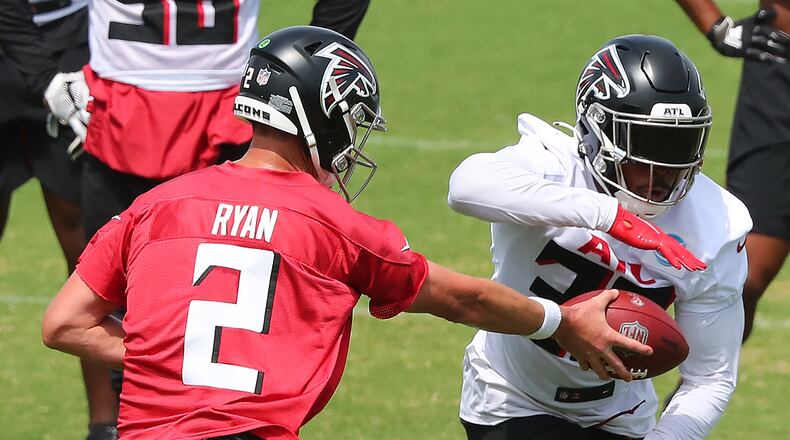 Falcons quarterback Matt Ryan hands off to running back Qadree Ollison (30) while running offensive drills during team practice at minicamp Wednesday, June 10, 2021, in Flowery Branch. (Curtis Compton / Curtis.Compton@ajc.com)