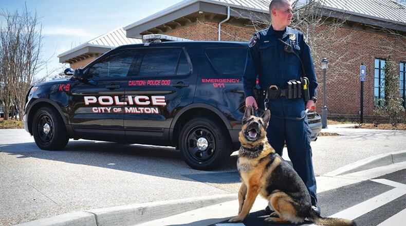 Milton police K9 “Kyro” with his handler, Officer Joshua Reece, in August 2019. The Milton City Council has approved retiring Kyro and selling him to Reece. MILTON POLICE DEPARTMENT via Facebook