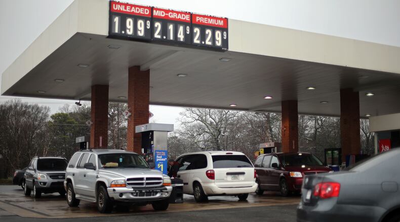 Cars jockey for position while trying to fill up on cheap gas at the Kroger on Moreland Avenue on Friday afternoon January 23, 2015. BEN GRAY / BGRAY@AJC.COM