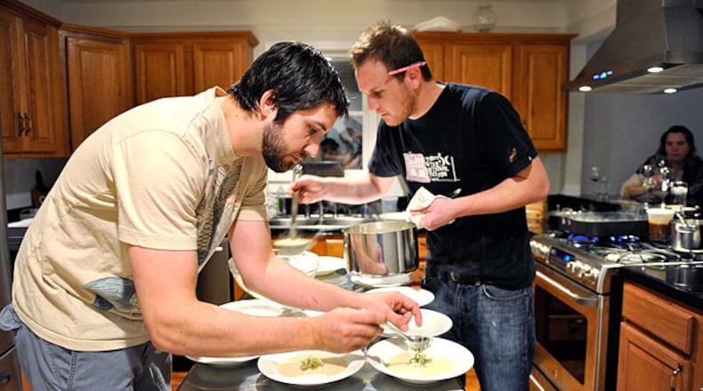 Ryan Hidinger (left) and his sous-chef Ben Barth serve fennel soup with apple relish at the Jan. 31 seating of Prelude to Staplehouse, an underground supper club.