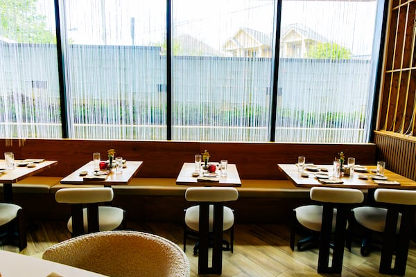 The dining room at Yuji Modern Japanese is wrapped in glass and features light wood. (Courtesy of Xzavier Nanthavongsa/Yuji Modern Japanese)