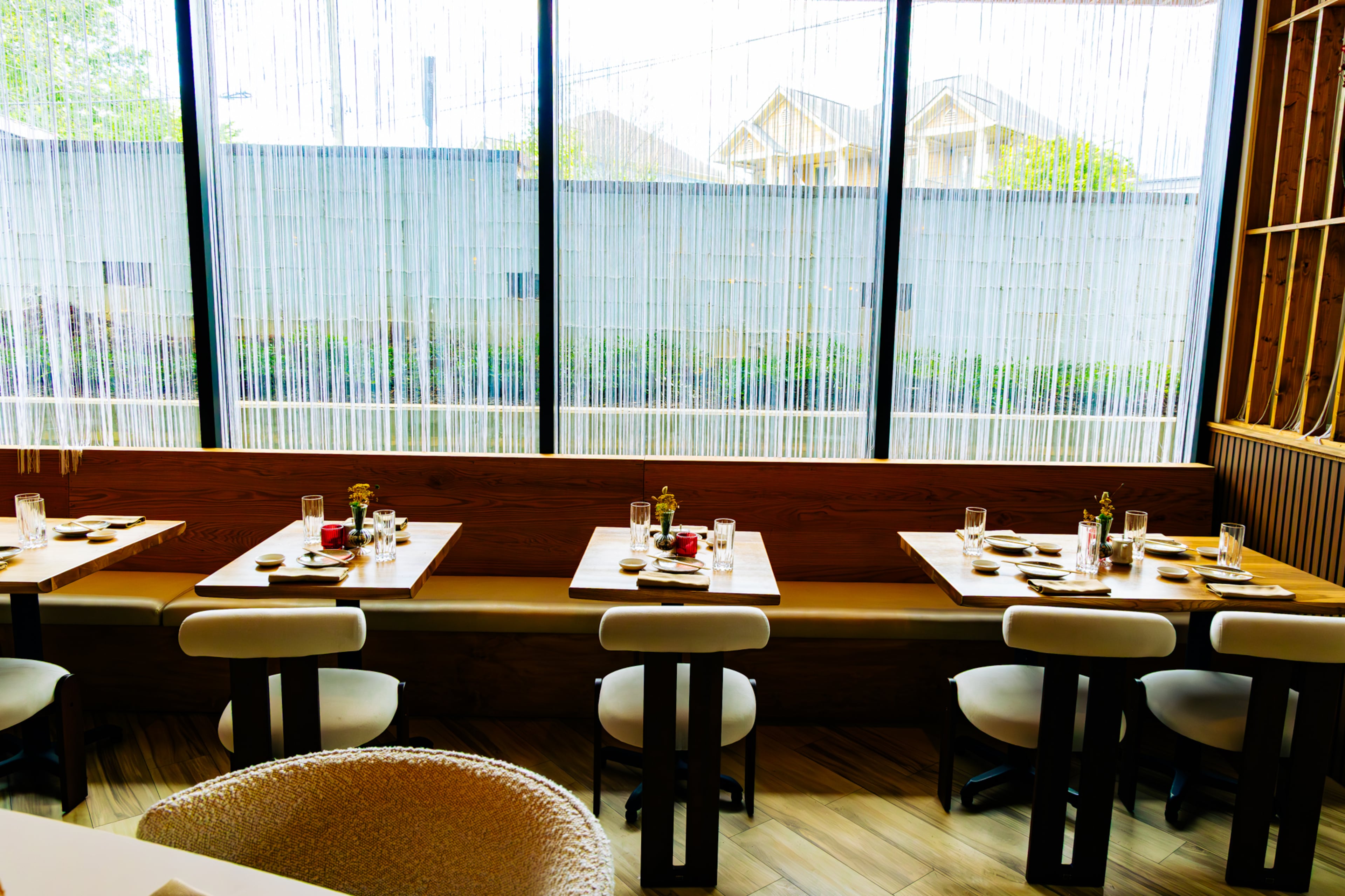 The dining room at Yuji Modern Japanese is wrapped in glass and clad in light wood. (Courtesy of Xzavier Nanthavongsa/Yuji Modern Japanese)