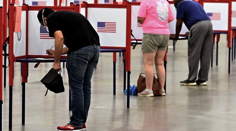 Voters fill out their ballots during in-person voting for the Kentucky primary.
