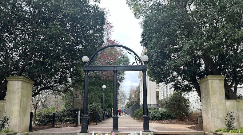 The Arch at the north campus entrance of the University of Georgia in Athens on Tuesday, Feb. 27, 2024. Flowers were left at the entrance after two college students died on the campus last week.