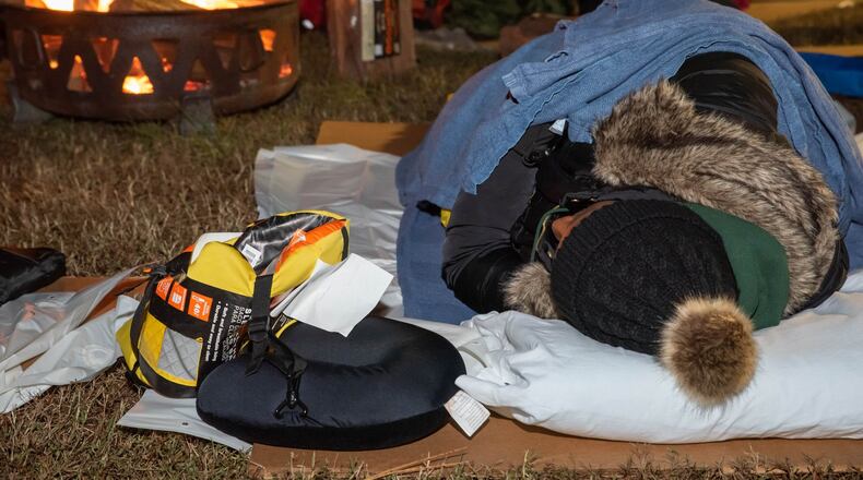 An Atlanta business executive tries to keep warm during the Covenant House Georgia Executive Sleepout last week. More than 160 sleepers braved the 30-degree temperatures to raise $897,000, which will go toward programs, services and housing to support Atlanta’s homeless youth. CONTRIBUTED BY TRACI KRUGER / TRALYNNPHOTOGRAPHY