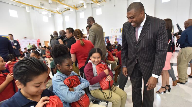 New Clayton County superintendent Morcease Beasley congratulates as students are getting a laptop as part of Internet Essentials program during Internet Essentials Back to School Event at Morrow Middle School in October. Clayton schools lagged state averages on the 2017 state report on student achievement and learning.