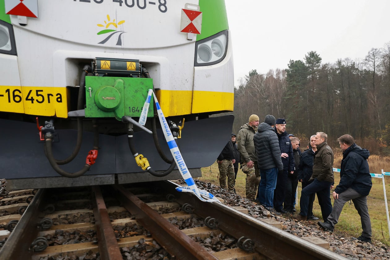 Prime Minister Donald Tusk, second right, visits site of the rail line Mika, that was damaged by sabotage, near Deblin, Poland, Monday, Nov. 17, 2025. (AP Photo/KPRM)