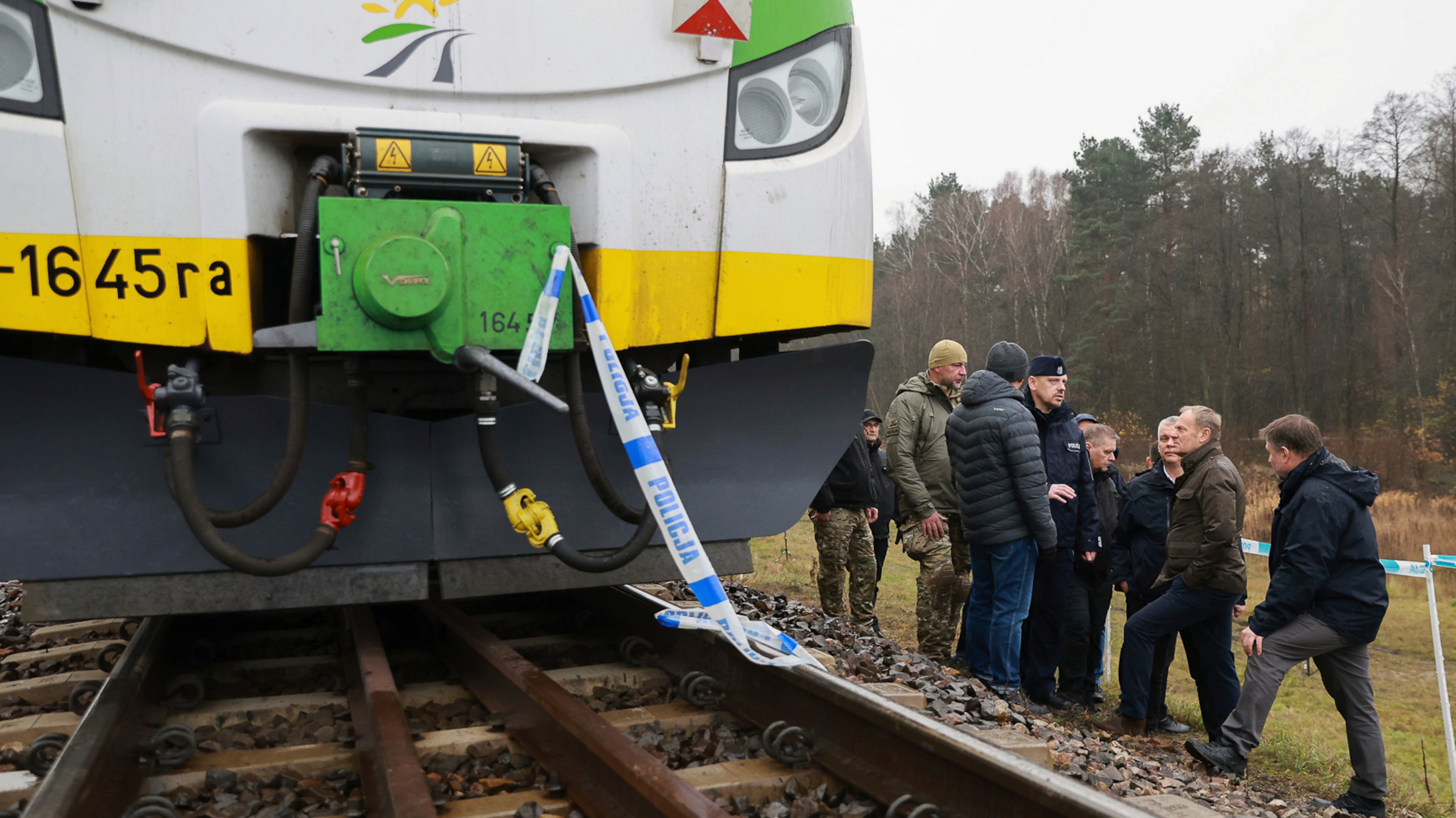 Prime Minister Donald Tusk, second right, visits site of the rail line Mika, that was damaged by sabotage, near Deblin, Poland, Monday, Nov. 17, 2025. (AP Photo/KPRM)