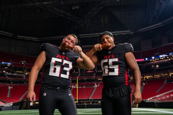 Atlanta Falcons offensive linemen Chris Lindstrom (left) and Matthew Bergeron helped introduce the jumbo dirty bird turkey leg, which will be available at Molly B's at Mercedes-Benz Stadium. (Courtesy of Levy Restaurants)