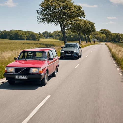 A Volvo 240 in red, followed by a Volvo XC60 Plug-in Hybrid. The 240 is probably the model Americans know best. It was produced from 1974 to 1993. (Brian Moody)