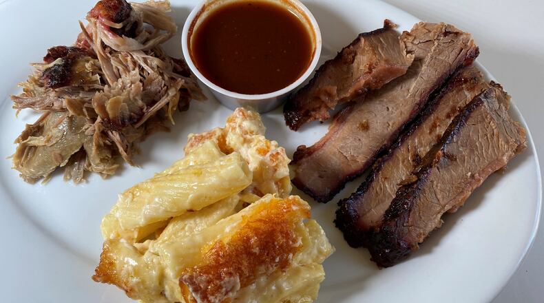 This order from Dave Poe's BBQ in Marietta includes pork, beef brisket and baked macaroni and cheese. Bob Townsend for The Atlanta Journal-Constitution