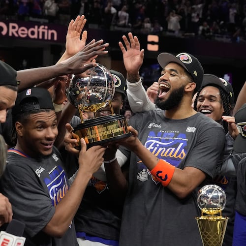 The New York Knicks hold the Eastern Conference Championship trophy after Game 4 in the Eastern Conference finals NBA basketball playoffs series against the Cleveland Cavaliers in Cleveland, Monday, May 25, 2026. (AP Photo/Sue Ogrocki)