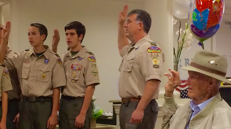 Scoutmaster Kevin Snyder and the Scouts from Troop 175 in Fayette County celebrate the birthday of 105-year-old Lamar Wallace (seated), the oldest living Eagle Scout. Photo by Bill Torpy