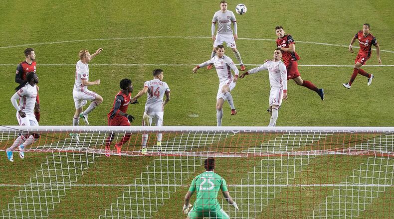 Toronto FC defender Nick Hagglund, second from right, climbs above Atlanta United forward Hector Villalba to send a header toward the goal during the second half of an MLS soccer match Saturday, April 8, 2017, in Toronto. (Chris Young/The Canadian Press via AP)