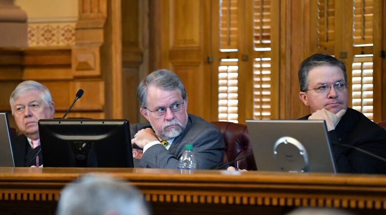 State House Appropriations Committee Chairman Terry England, center, listens as Gov. Brian Kemp discusses his proposed budget during hearings earlier in the legislative session. England said “the brunt of the cuts” in Kemp’s spending plan appear to target work the Legislature did to shore up Georgia’s struggling rural communities. (Hyosub Shin / Hyosub.Shin@ajc.com)
