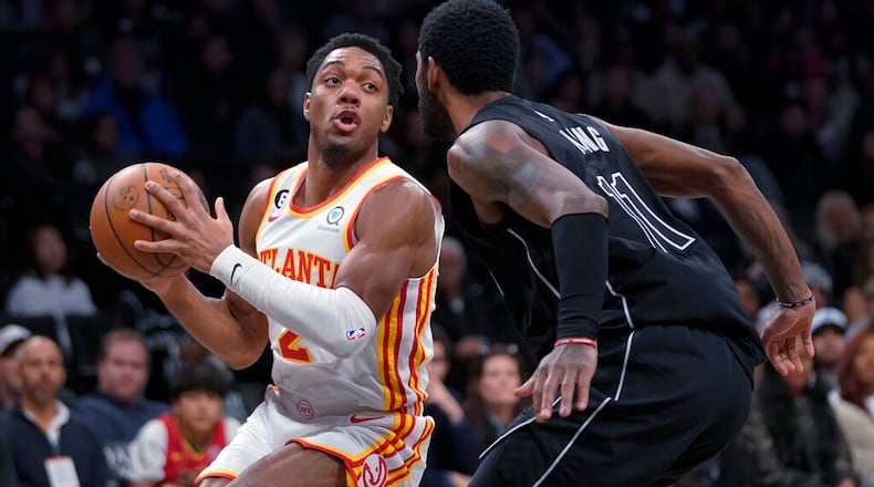 Atlanta Hawks guard Trent Forrest (2) drives against Brooklyn Nets guard Kyrie Irving during the first half of an NBA basketball game Friday, Dec. 9, 2022, in New York. (AP Photo/Mary Altaffer)