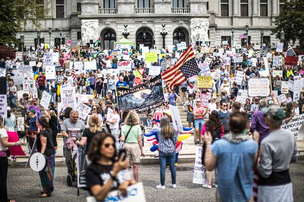 Protesters rally at the state capitol in Harrisburg, Pa., during the Day of Action protest against the Trump Administration. Saturday, April 19, 2025. (Zach Gleiter/The Patriot-News via AP)