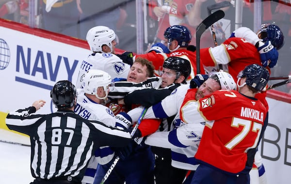 Officials try to separate the Tampa Bay Lightning and the Florida Panthers as they scuffle during the second period in Game 3 of an NHL hockey Stanley Cup first-round playoff series, Saturday, April 26, 2025, in Sunrise, Fla. (AP Photo/Rhona Wise)