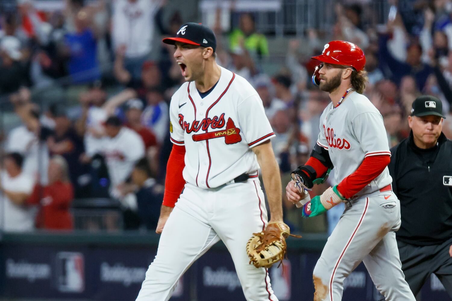 Atlanta Braves first baseman Matt Olson (28) reacts after forcing out Philadelphia Phillies’ Bryce Harper at first base on a fly out by Nick Castellanos to end the ninth inning of NLDS Game 2 in Atlanta on Monday, Oct. 9, 2023.   (Miguel Martinez / Miguel.Martinezjimenez@ajc.com)