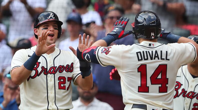 Braves outfielder Adam Duvall is greeted at home by Austin Riley (left) after hitting a two-run homer to take a 5-1 lead over the Washington Nationals during the sixth inning Sunday, Aug. 8, 2021, at Truist Park in Atlanta. (Curtis Compton / Curtis.Compton@ajc.com)