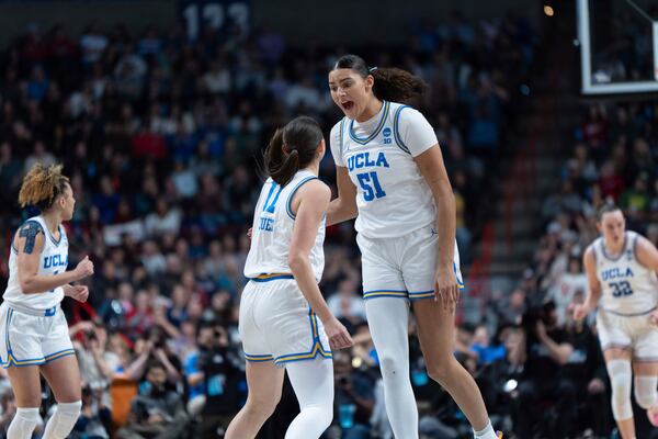 UCLA center Lauren Betts (51) reacts with UCLA guard Gabriela Jaquez (11) during the second half of a game against LSU in the Elite Eight of the NCAA college basketball tournament, Sunday, March 30, 2025, in Spokane, Wash. (AP Photo/Jenny Kane)