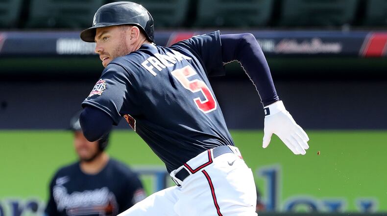 Atlanta Braves first baseman Freddie Freeman trys to beat out a ground ball during the fourth inning making his first scheduled spring training appearance against the Minnesota Twins in a MLB spring training baseball game at CoolToday Park on Friday, March 5, 2021, in North Port. The Twins turned a double play on Freeman. Curtis Compton / Curtis.Compton@ajc.com