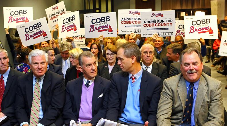 Braves GM Frank Wren (from left), Braves Team President John Schuerholz, Braves Executive Vice Presidents Derek Schiller and Mike Plant at the Cobb commission meeting at which the Braves stadium deal was approved. Curtis Compton / AJC file