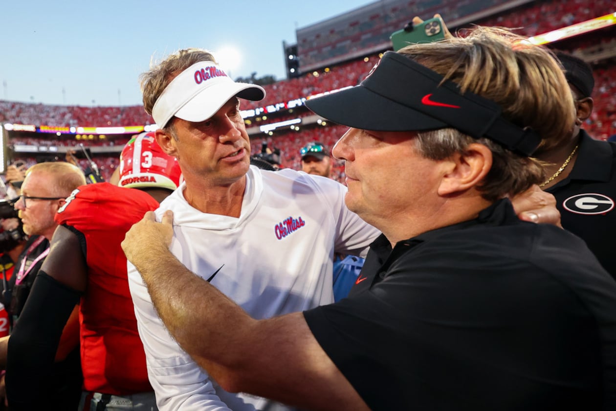 Mississippi’s Lane Kiffin (left), shown with Georgia’s Kirby Smart, has taken a spot at the head table as the most sought-after head coach amid all the current job openings after turning Ole Miss into a top-10 program. (Colin Hubbard/AP)