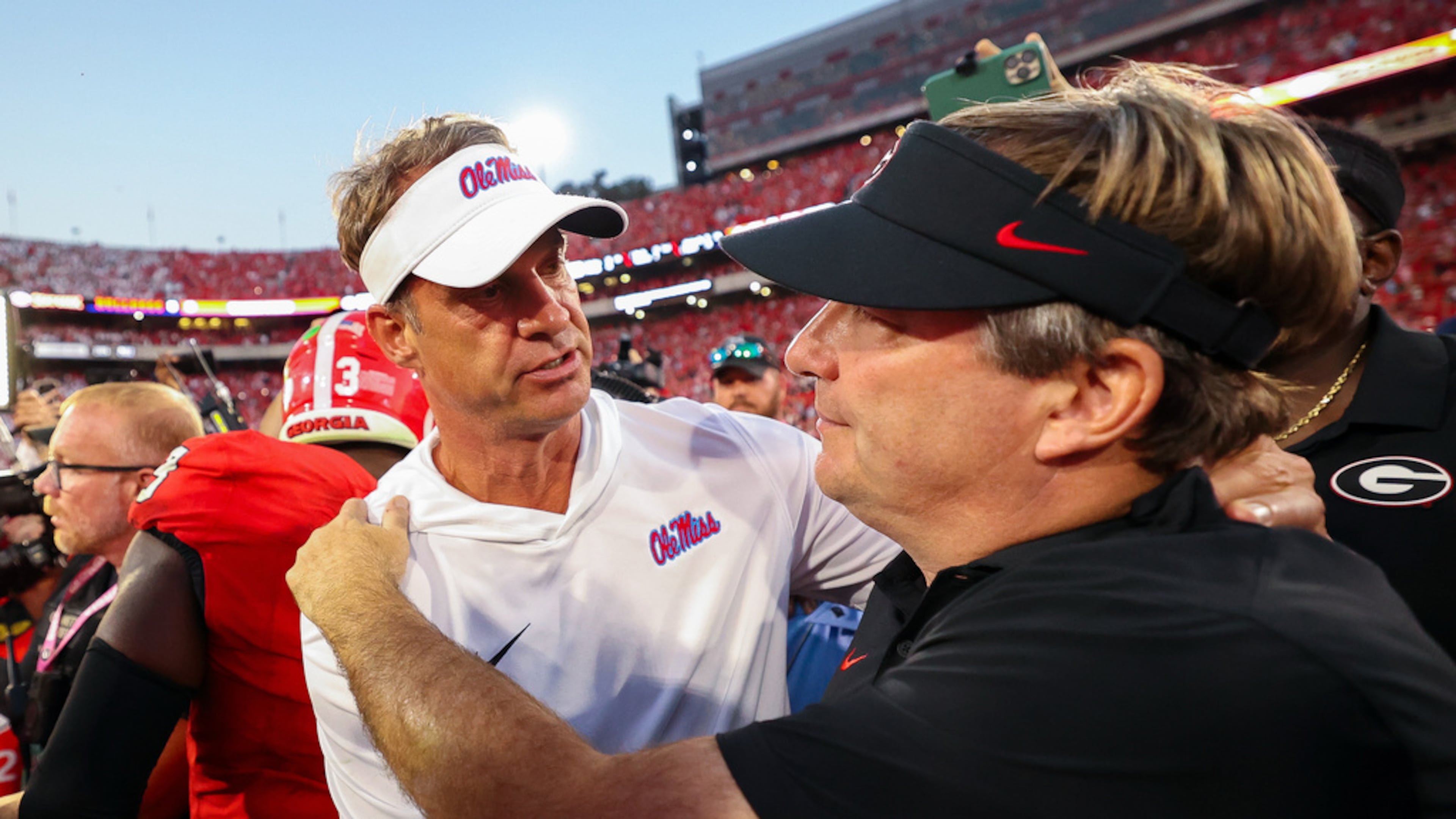 Mississippi’s Lane Kiffin (left), shown with Georgia’s Kirby Smart, has taken a spot at the head table as the most sought-after head coach amid all the current job openings after turning Ole Miss into a top-10 program. (Colin Hubbard/AP)