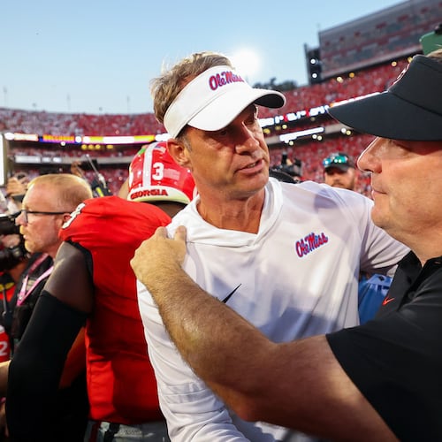 Mississippi’s Lane Kiffin (left), shown with Georgia’s Kirby Smart, has taken a spot at the head table as the most sought-after head coach amid all the current job openings after turning Ole Miss into a top-10 program. (Colin Hubbard/AP)